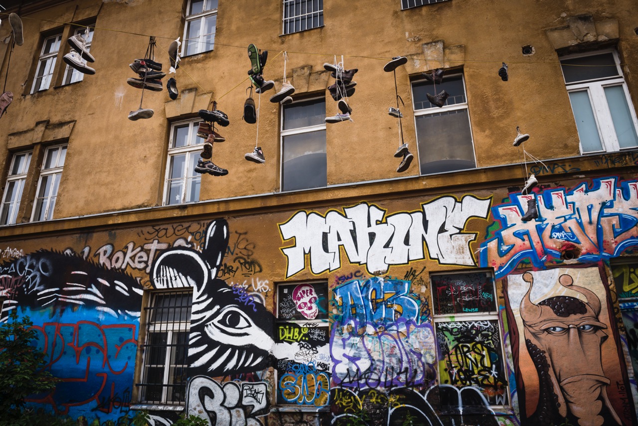 Graffiti and shoes hanging from wires, Metelkova City Autonomous Cultural and Social Cente, Ljubljan